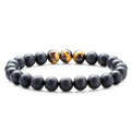 Geometric couple bracelet made of matte black agate beads with a tiger eye stone.