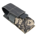 Black tactical MOLLE waist bag with elastic cord buckle, shown next to a small flashlight