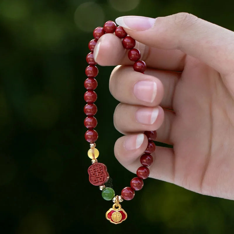 Cinnabar bracelet with raw emperor sandstone beads and a fu character charm in new Chinese style.