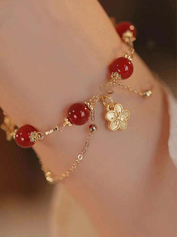 Red agate double layer bracelet for women with carved peach blossom and flower designs.