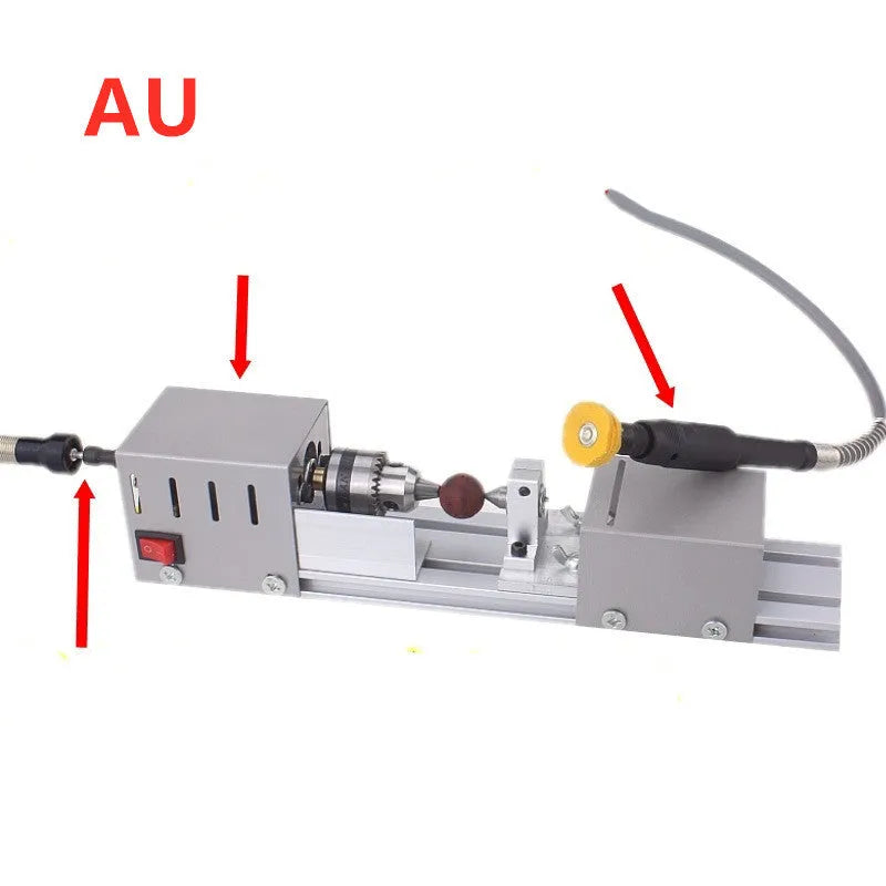 Silver metal mini woodworking lathe with carving knives on a workbench