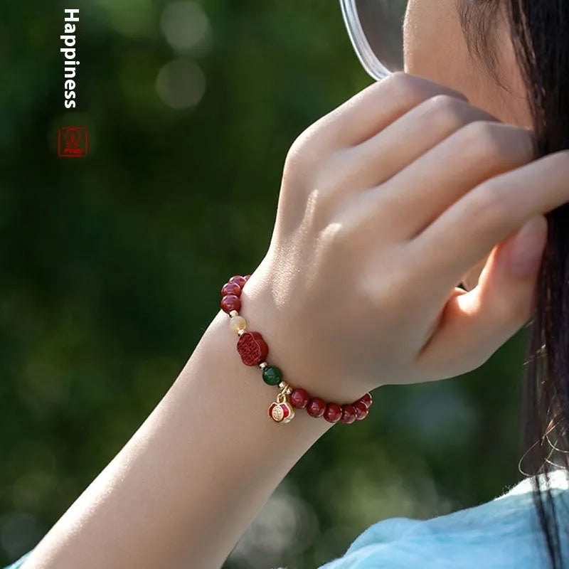 Cinnabar bracelet with raw emperor sandstone beads and a fu character charm in new Chinese style.
