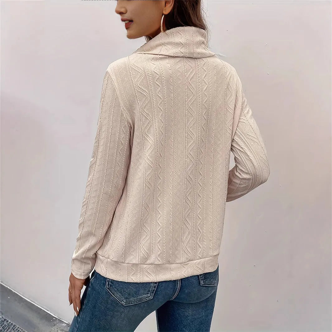 Apricot coloured long sleeve hooded pullover sweater with a drawstring, shown on a hanger.
