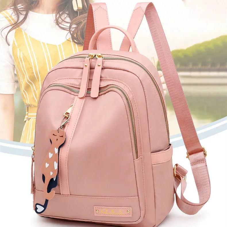 Women's black nylon backpack with waterproof lining and multiple zippered compartments