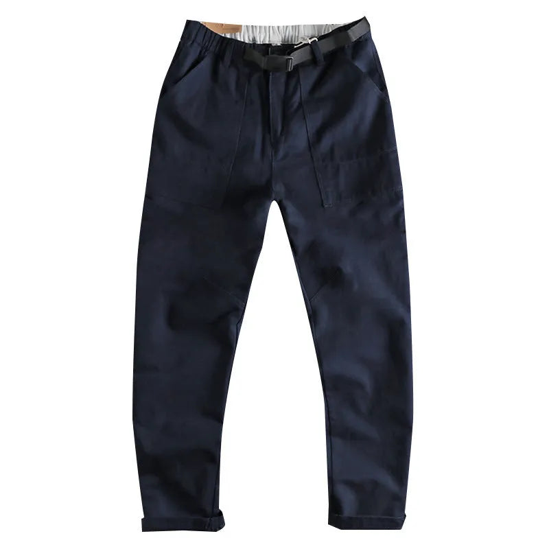 Men's khaki work trousers with a buckle belt and three-dimensional cutting on a hanger.