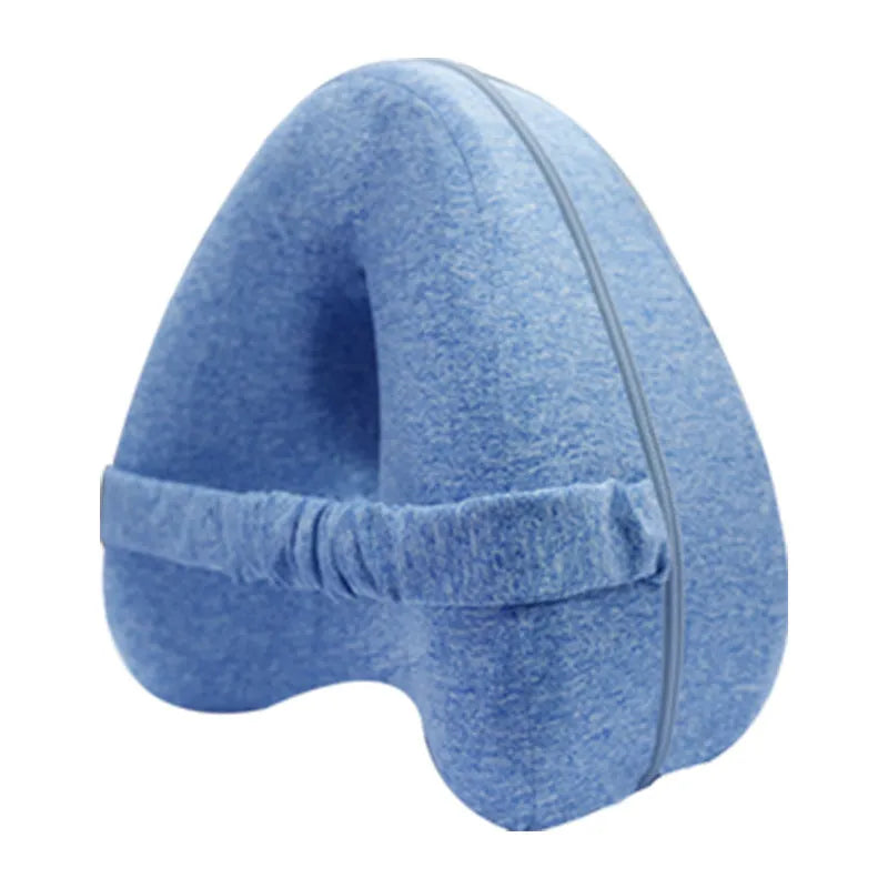 Love heart-shaped dark blue memory foam leg pillow for adults on a bed.