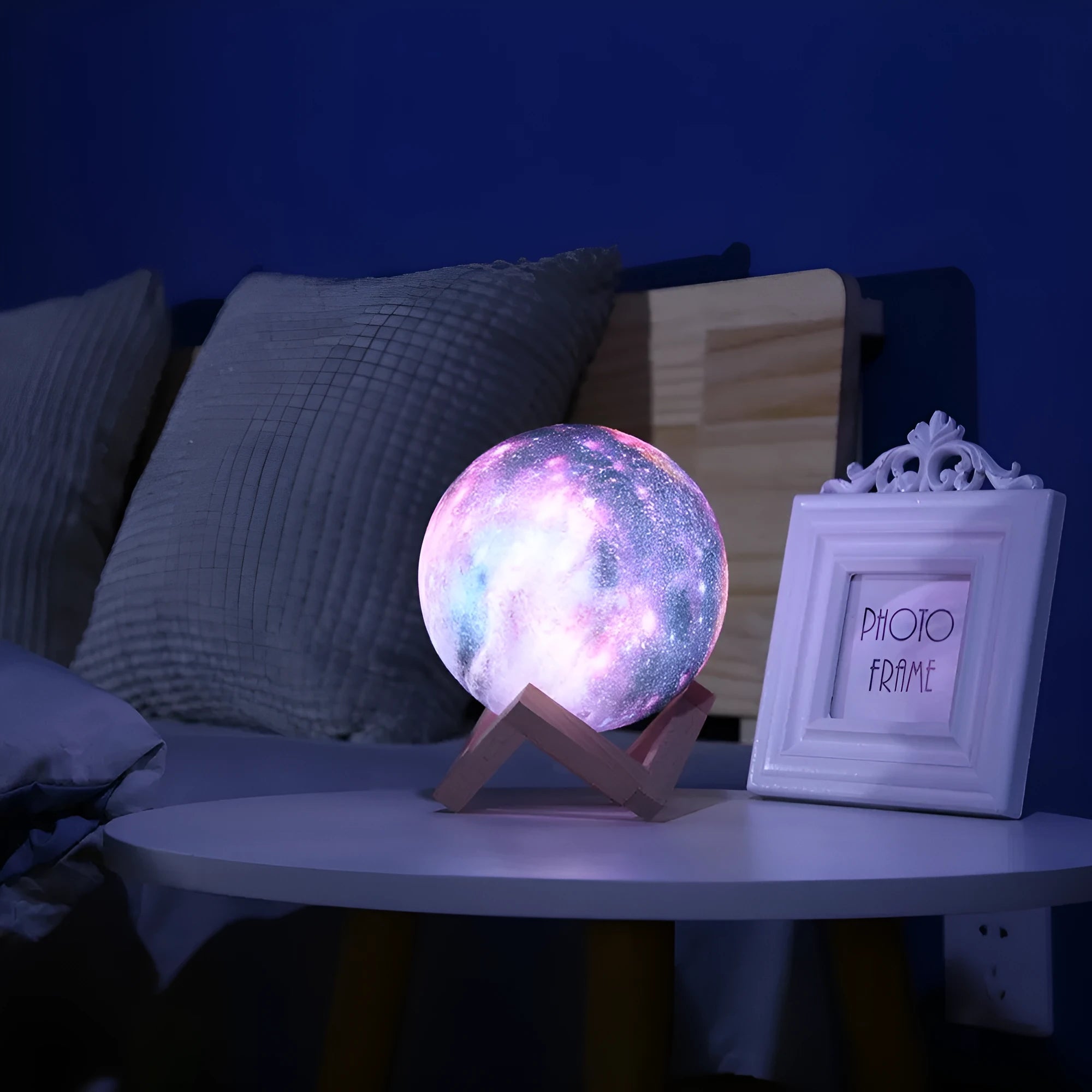3D printed spherical moon night light with textured surface, shown with remote control.