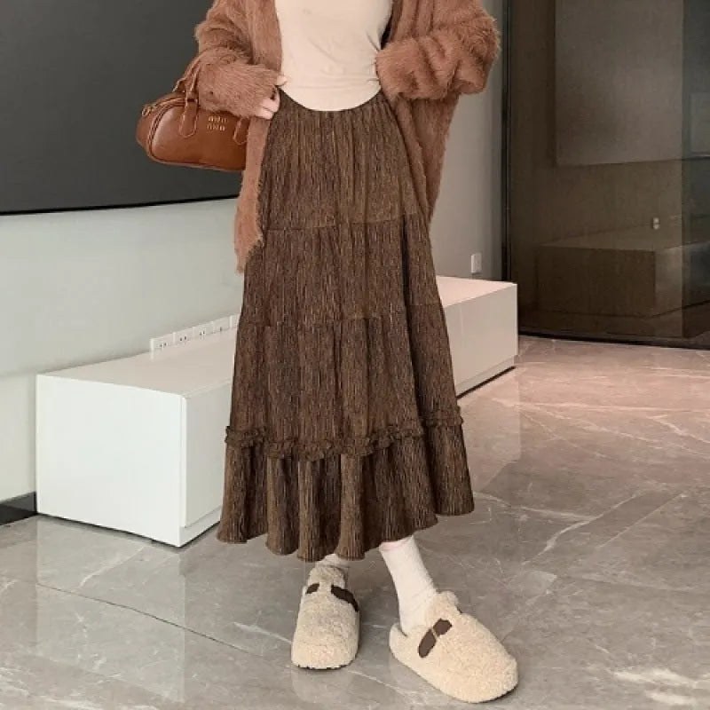 Women's milky white corduroy A-line midi skirt with an elastic waistband on a hanger.
