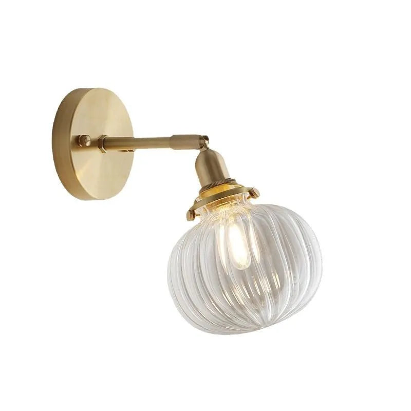 Pumpkin-shaped glass wall lamp with a curved shade on a wall, shown in water ripple transparent and solid blue glass options.