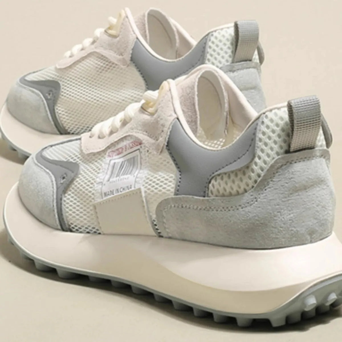 Women's grey retro sneaker with round toe and rubber sole showing mesh lining interior