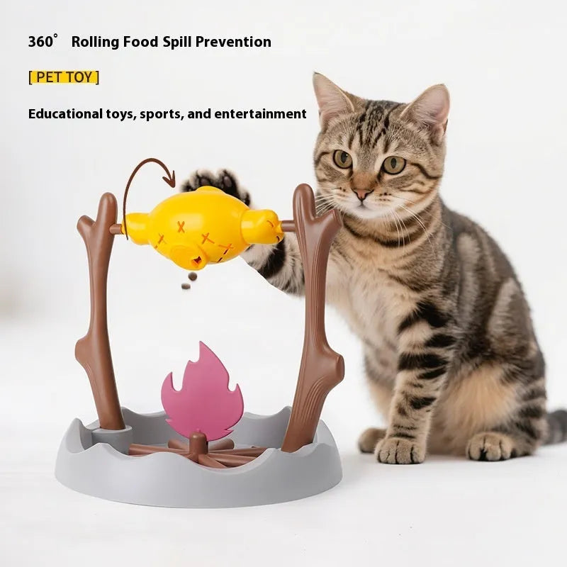 White and grey tumbling cat feeder toy with treat compartment on a wooden floor.