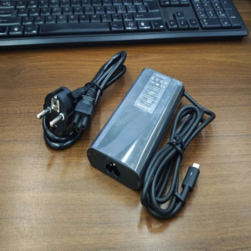 Black 65W Type-C laptop power adapter with multiple international power cords