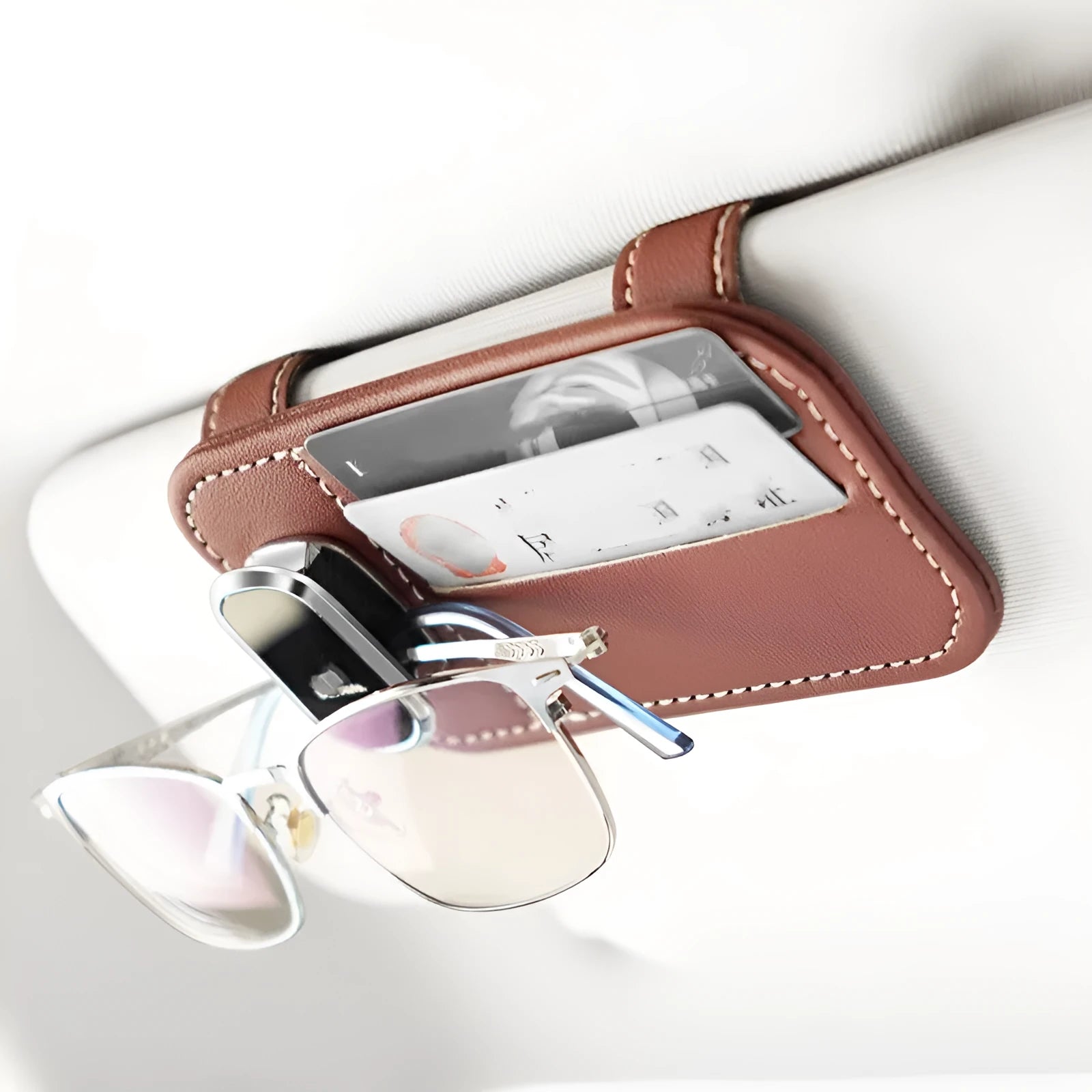 Beige leather car sun visor card holder with a glasses clip shown installed on a vehicle visor.