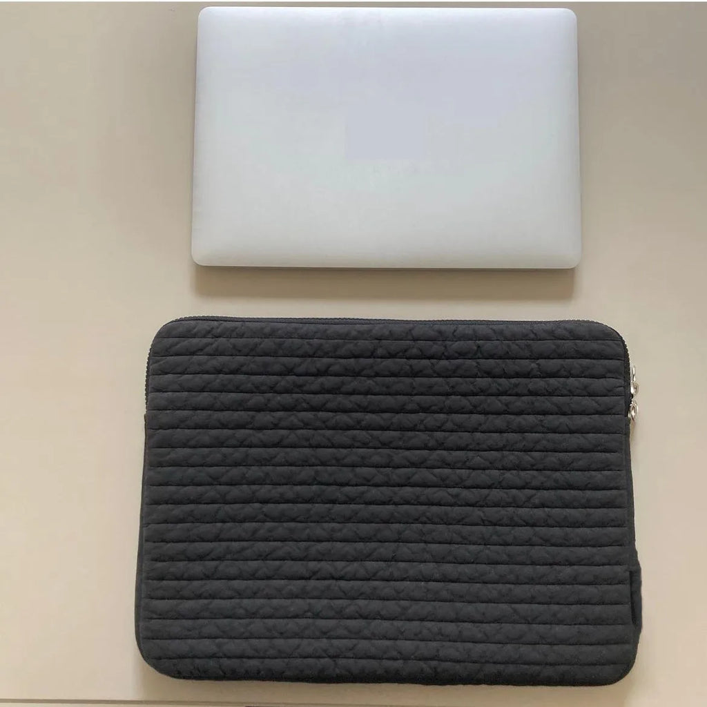 Black and white hand-held anti-seismic cotton laptop clutch bag for tablets, showing coin pocket.