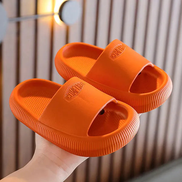 Children's non-slip EVA slippers in bright colours, showing the 1.5cm thick sole.