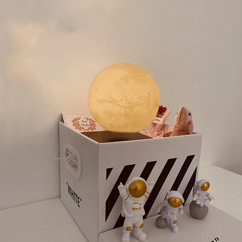 Floating magnetic levitation moon planet lamp with LED light and astronaut figures on desk