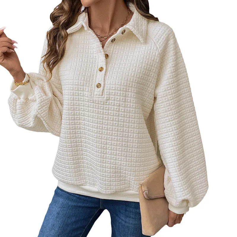 Women's milky white sweater with a polo collar and long sleeves laid flat.