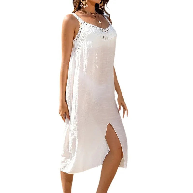 White crocheted beach dress for women with hollow weave and bottom slit design.