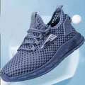 Men's beige casual sneakers with mesh lining, synthetic leather upper, and lace-up front closure