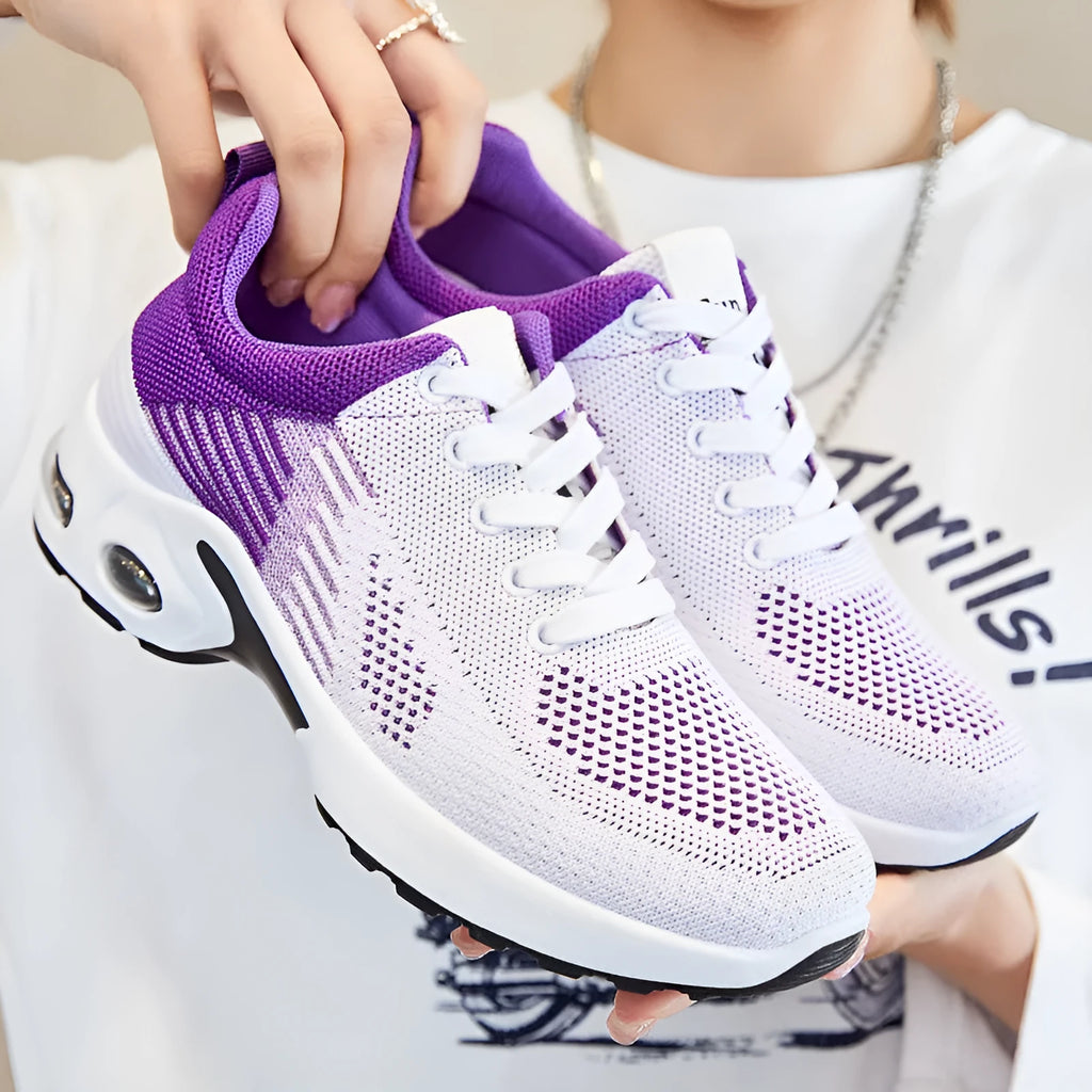 Women's pink Flyknit casual running shoes with mesh lining and flat heel on a white background