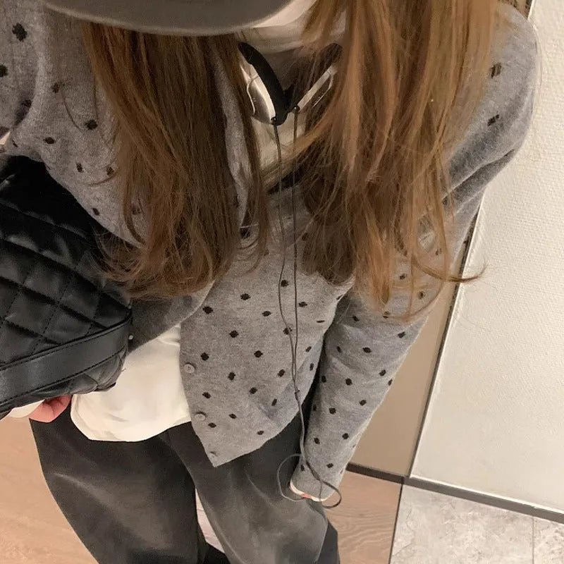 Women's grey dot pattern knitted cardigan with crocheted flower detail and long sleeves