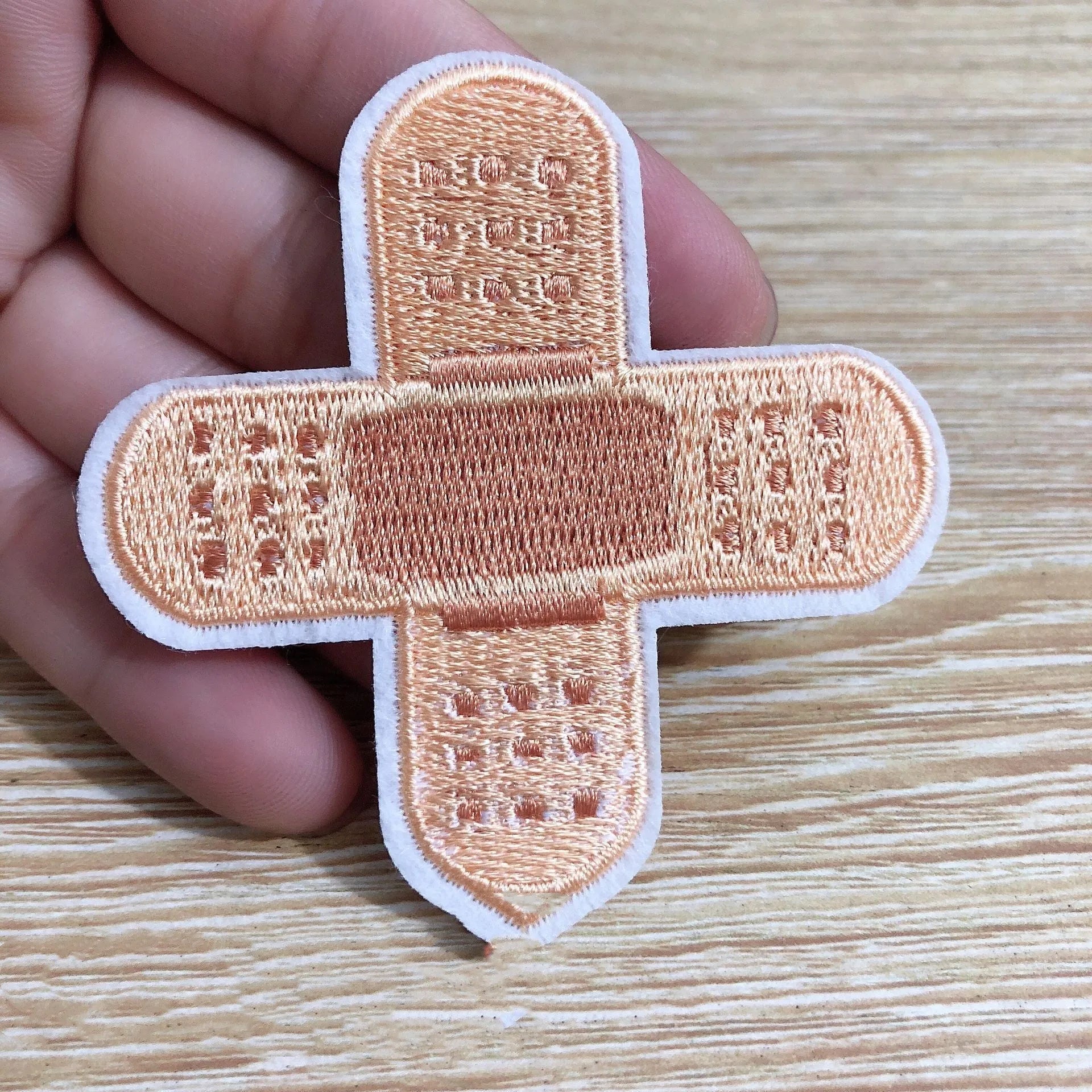 Ten computer embroidered fabric patches with detailed raised designs for clothing decoration