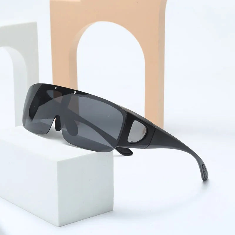 Sporty polarised myopia sunglasses with multiple interchangeable lenses including black, grey, and night vision, on a dark background.
