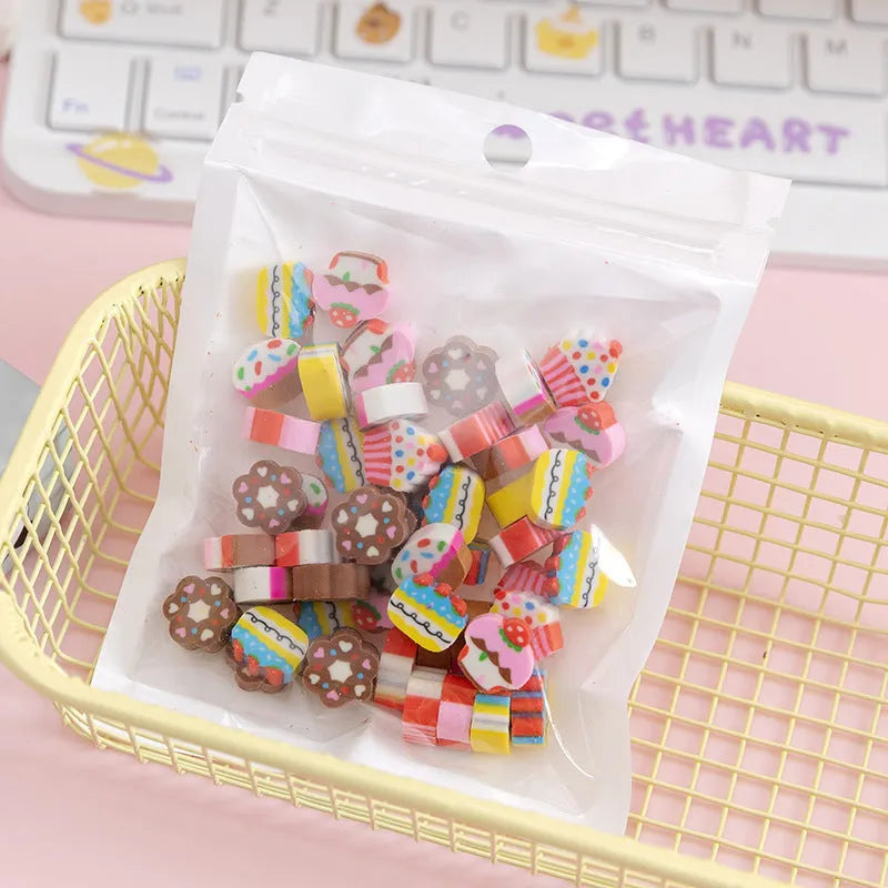 50 colourful cartoon mini erasers in pearlescent bags showing fruit, animal, and holiday designs