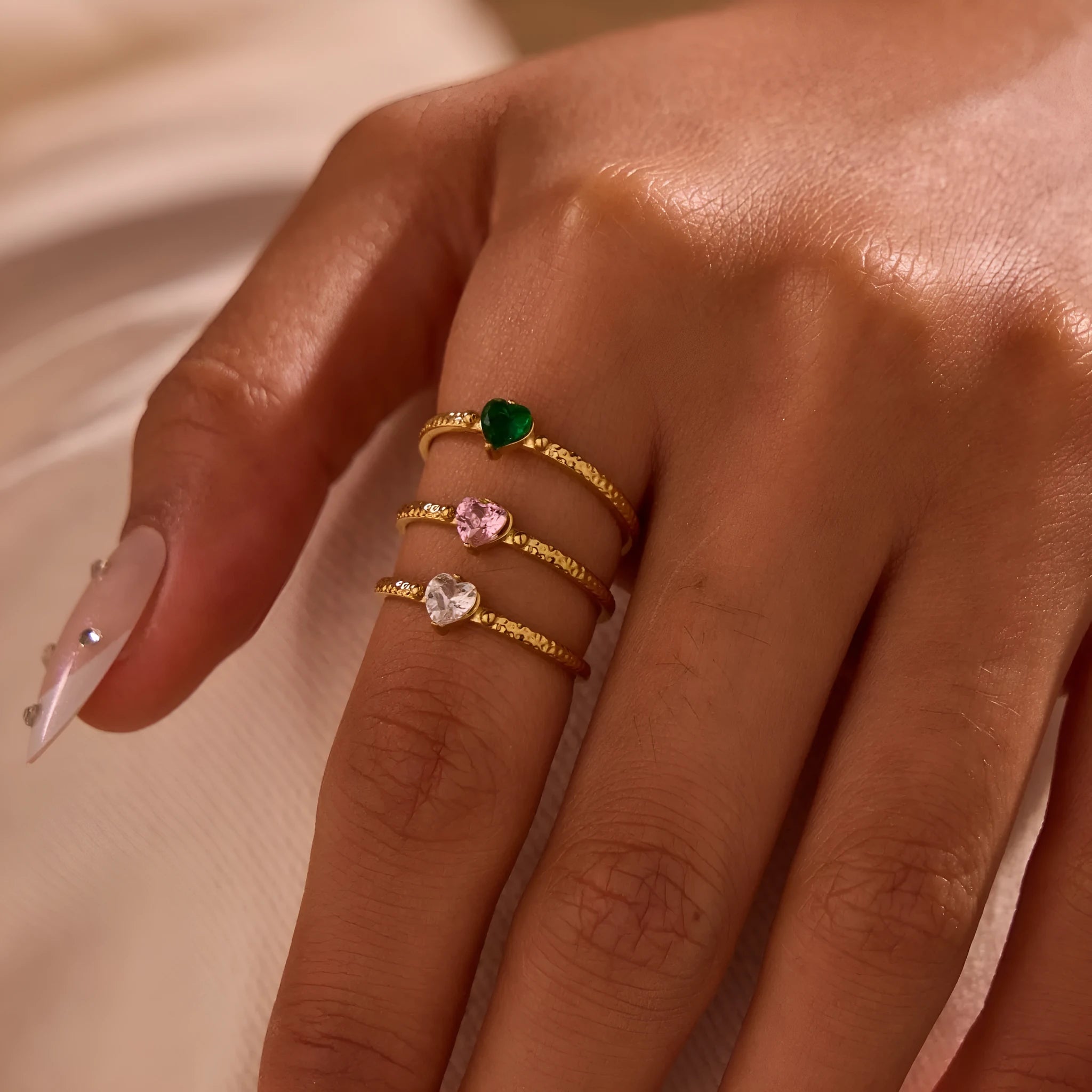Open-ended stainless steel ring featuring a geometric heart shape with an inlaid zircon stone.