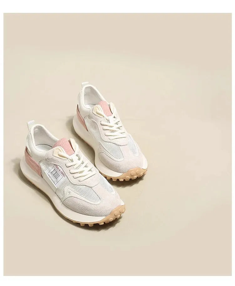 Women's grey retro sneaker with round toe and rubber sole showing mesh lining interior