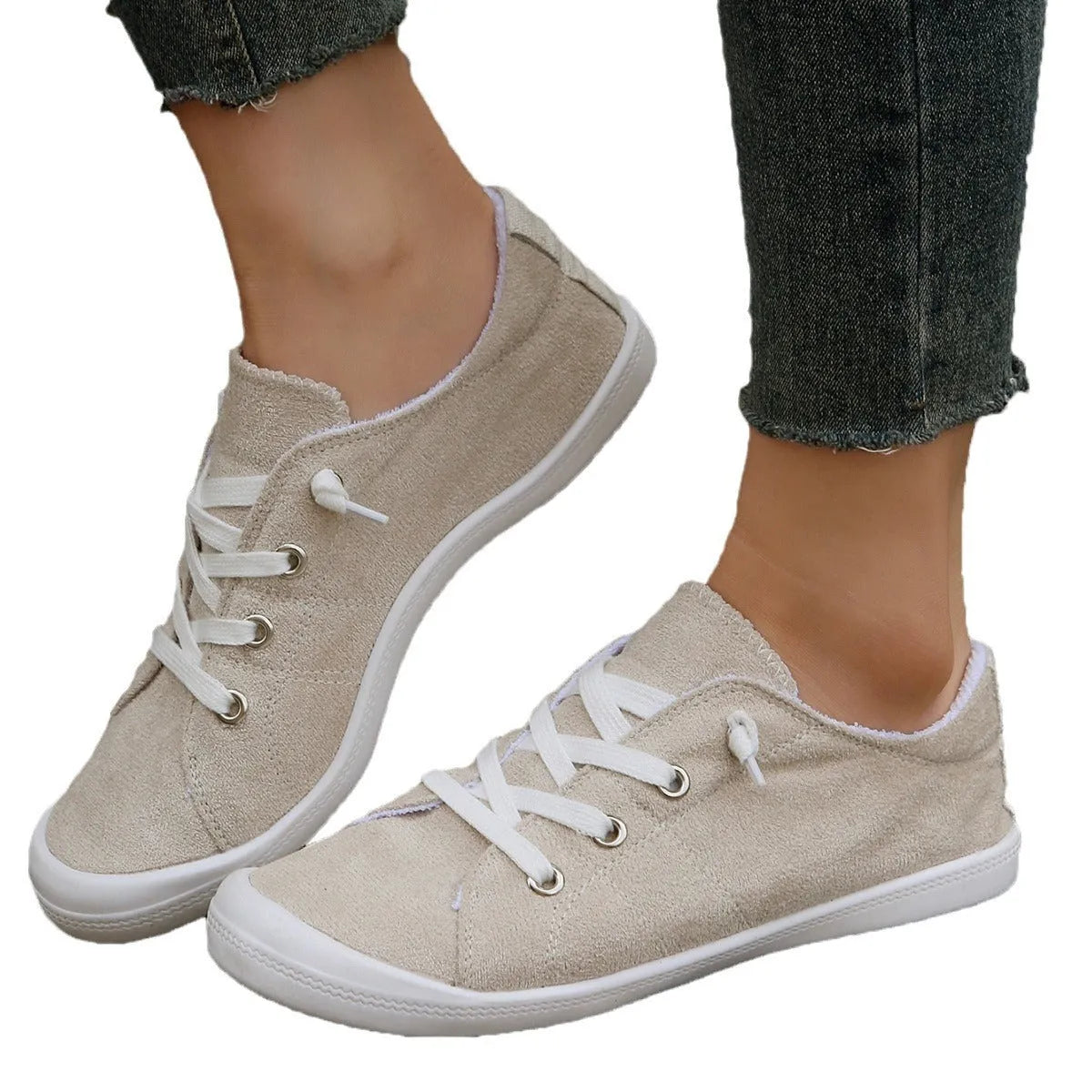 Women's creamy white casual sneakers with fabric upper and rubber sole on multiple surfaces