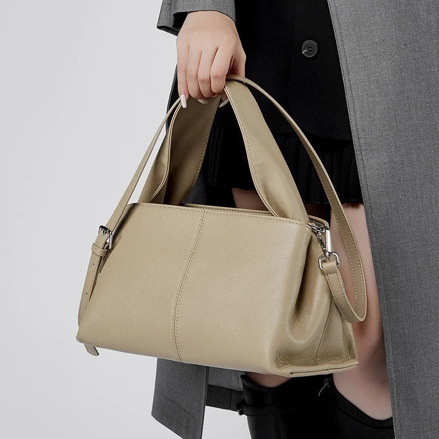 Women's genuine leather messenger bag in horizontal square shape with double shoulder strap, shown in apricot colour.