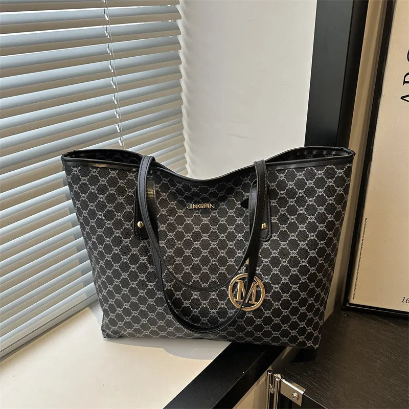 Structured black PU shoulder bag with sewing thread detail and a polyester lining.
