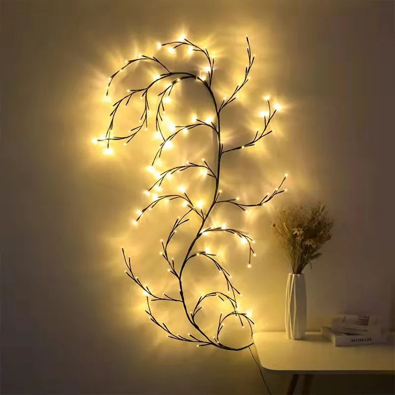 Flexible willow vine LED garland with birch bark texture and warm white lights shaped on a wall.