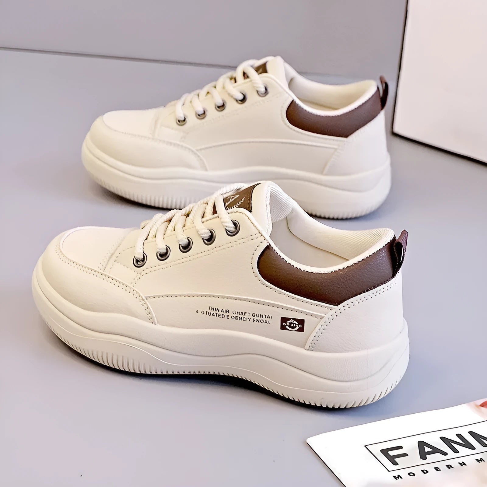 Women's white Korean-style low-top pumps with cross straps and round toe on a rubber sole.