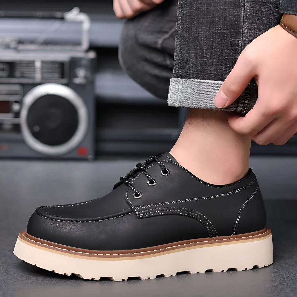 Men's black retro Martin boots with round toe and low-top design on a plain background