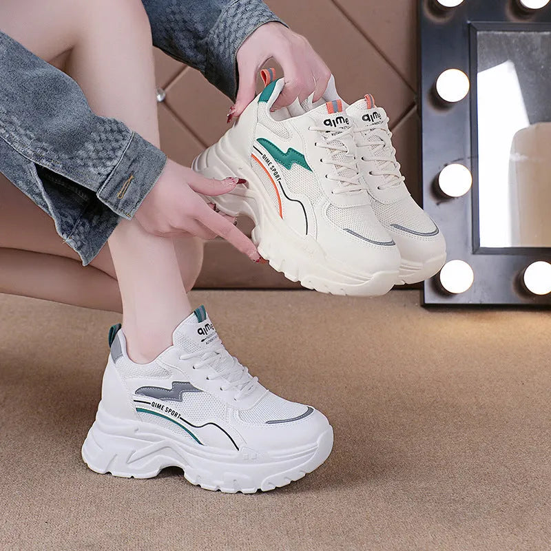 Beige women's lace-up dad shoes with cross straps and a round toe, on a white background.