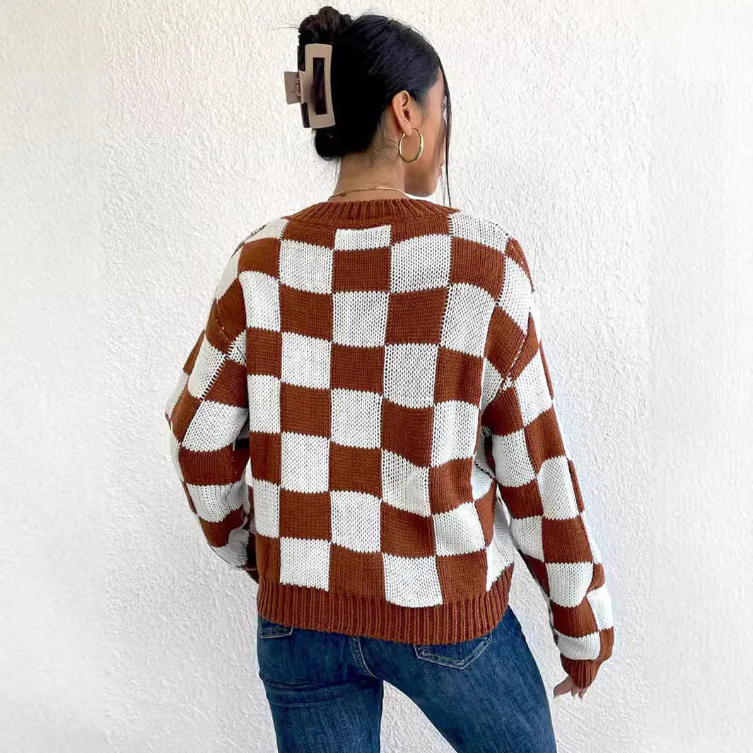 Dark brown plaid loose round neck acrylic pullover sweater on a hanger