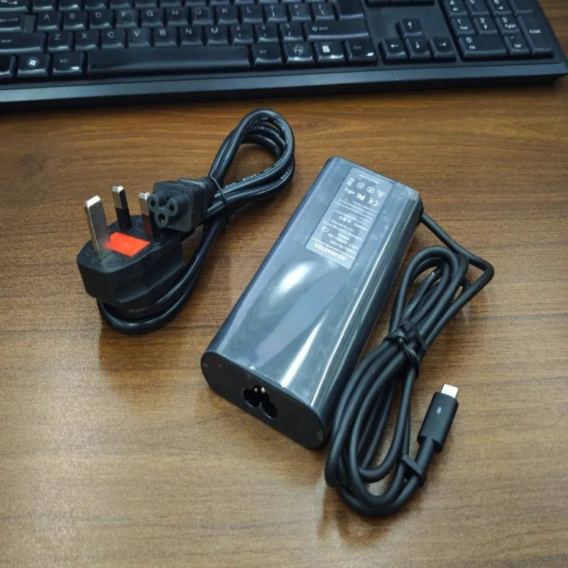 Black 65W Type-C laptop power adapter with multiple international power cords