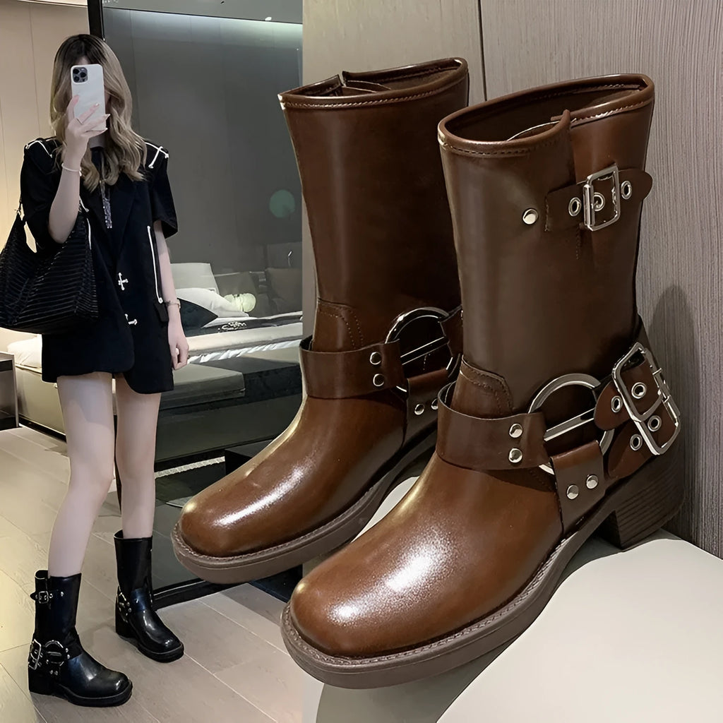 Black women's platform boots with a silver metal buckle strap on the ankle.