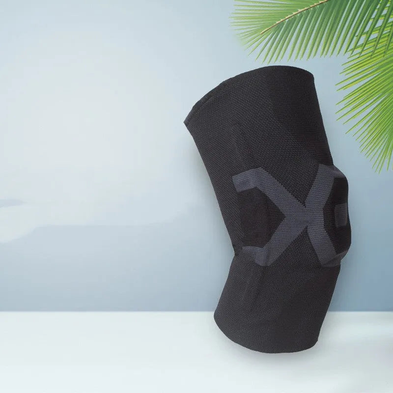 Men's silicone knee pad for sports protection in a two-tone colour, shown on a knee.