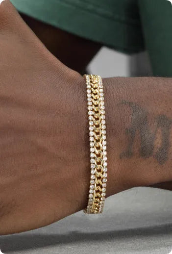 Gold-coloured tennis bracelet with gemstone detail on a titanium steel band.