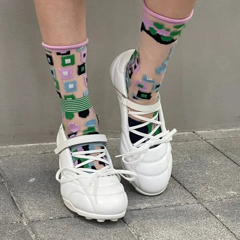 Women's silver lace-up sports shoes with a decorative bow and platform sole, showing round toe and low-top design.