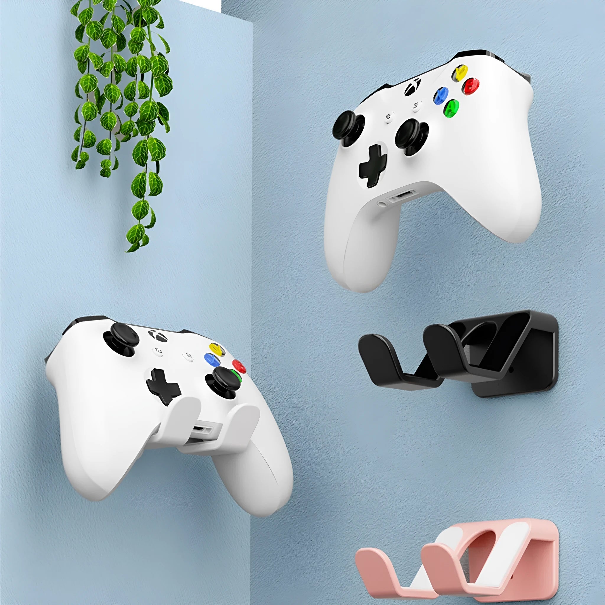 Universal game controller wall hanging rack in black, white, or pink colours with adhesive mounting options