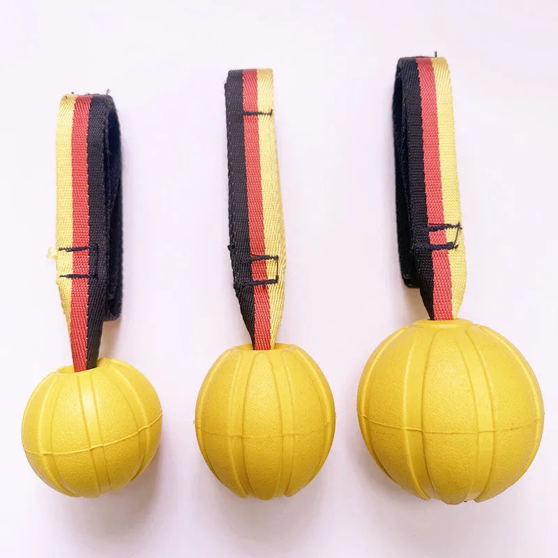 Camouflage and yellow floating EVA dog balls with tether strings in three different sizes on blue background.