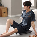 Man's light blue ice silk pyjama set with short sleeves and loose shorts laid flat.