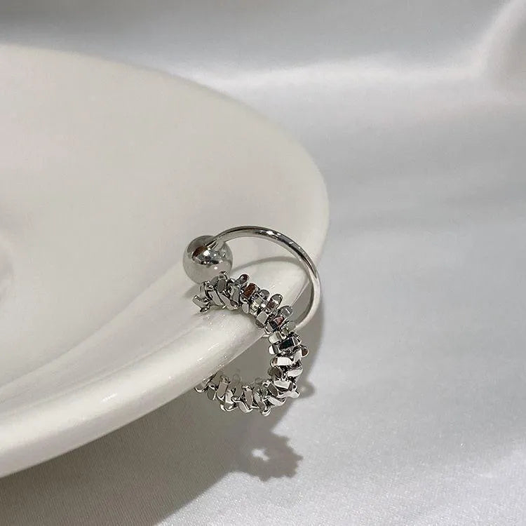 A pair of frosty-finish geometric alloy earrings with ear clip fastenings.