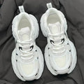 Beige mesh platform sports shoes with wedge muffin heel and lace-up front.
