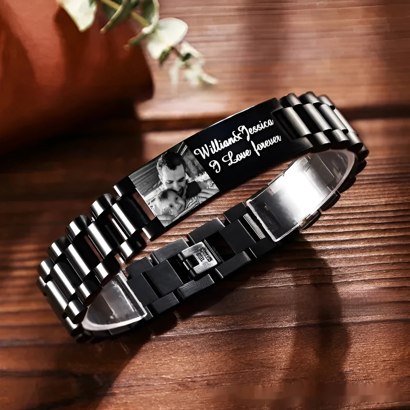 Men's titanium steel curved heart shape bracelet with black lettering.