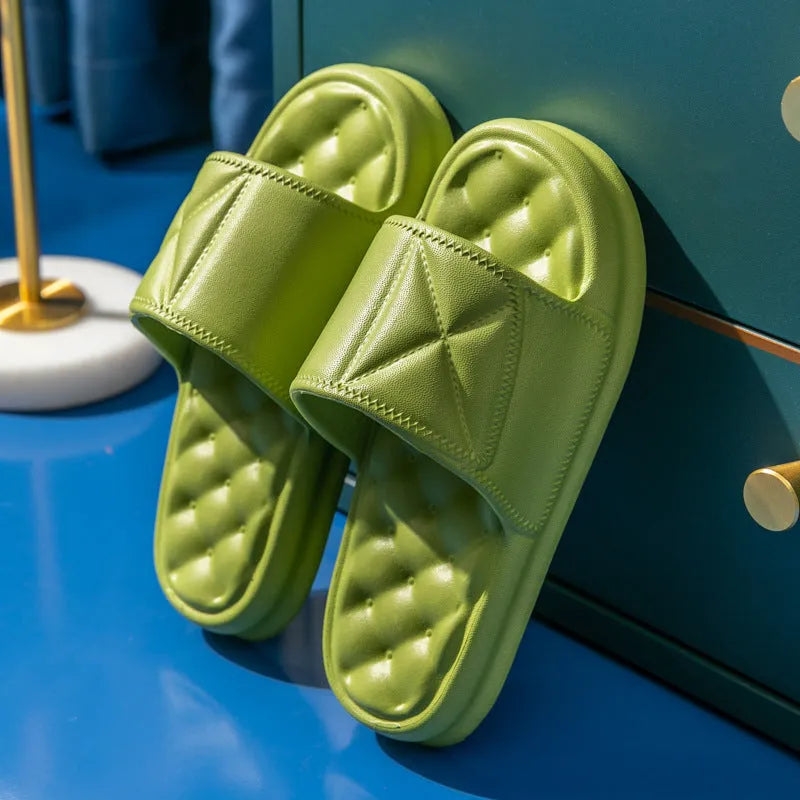 Soft EVA non-slip bathroom slippers with thick sole in assorted colours on a bathroom floor.